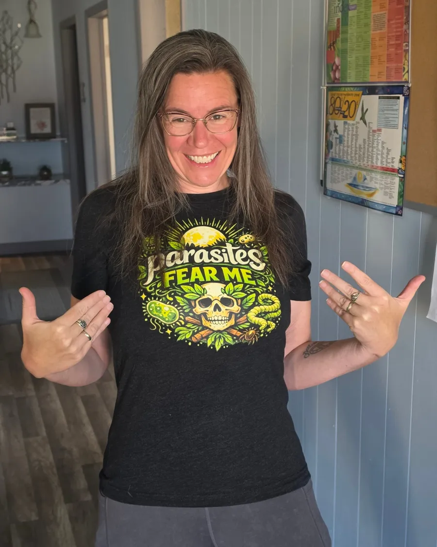 April at her office in a Parasites Fear Me shirt